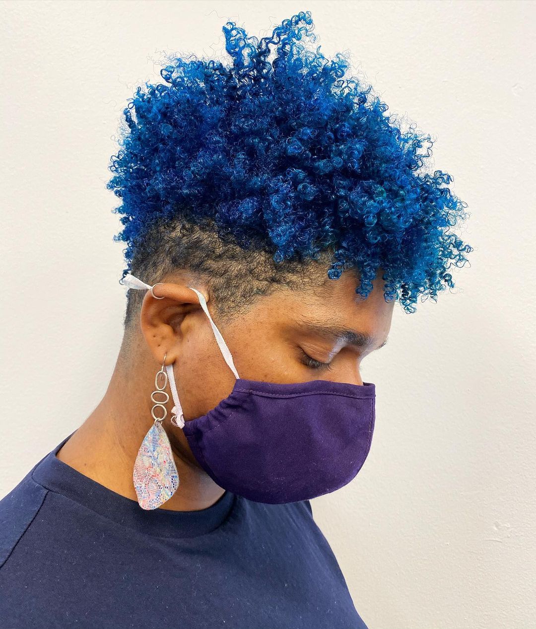 In a stylish blue Mohawk